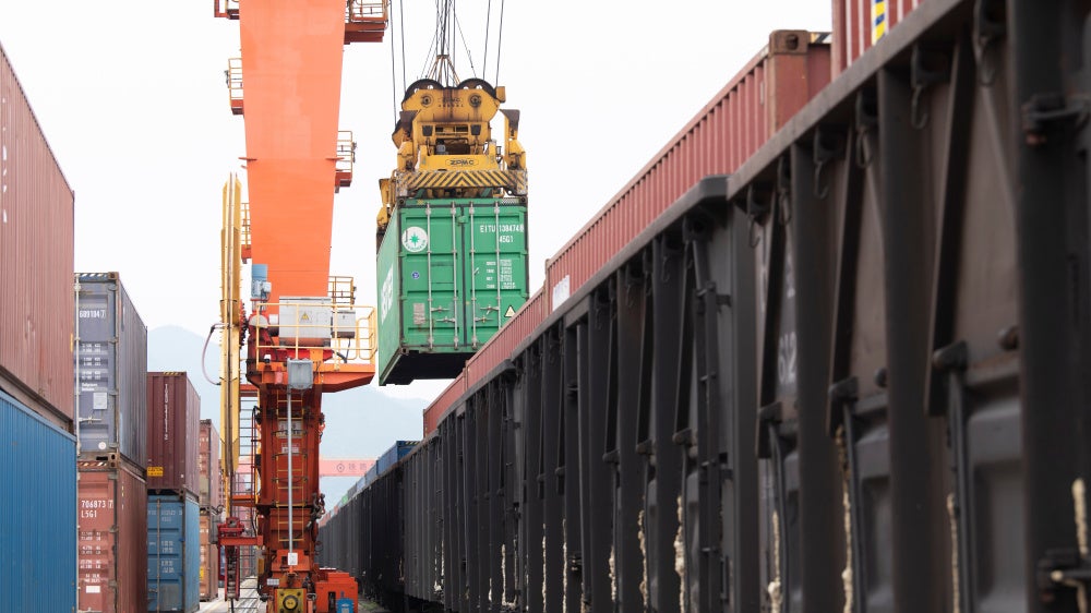 Containers are loaded onto a China-Europe Railway Express (Yiwu-Xinjiang-Europe) market procurement train at the Jinhua Yiwu Railway West Station in Jinhua, China, on June 8, 2026.