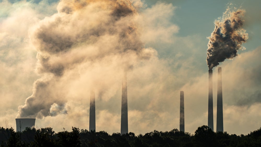 Pollution and steam are seen rising from the stacks of the Miami Fort Power Station along the Ohio River, in North Bend, Ohio, on July 23, 2026. 