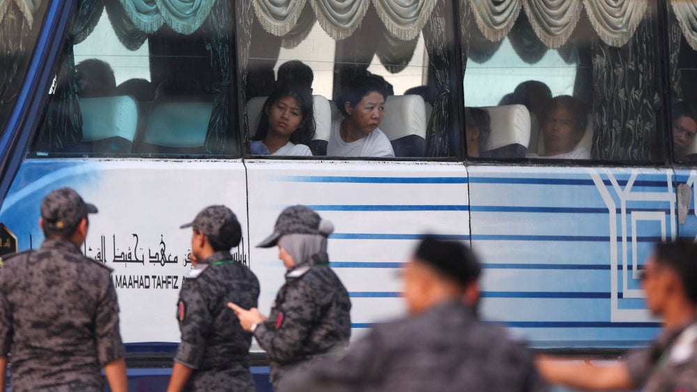 Myanmar nationals to be repatriated from Malaysia sit inside a bus, at Lumut, Malaysia, September 29, 2026.