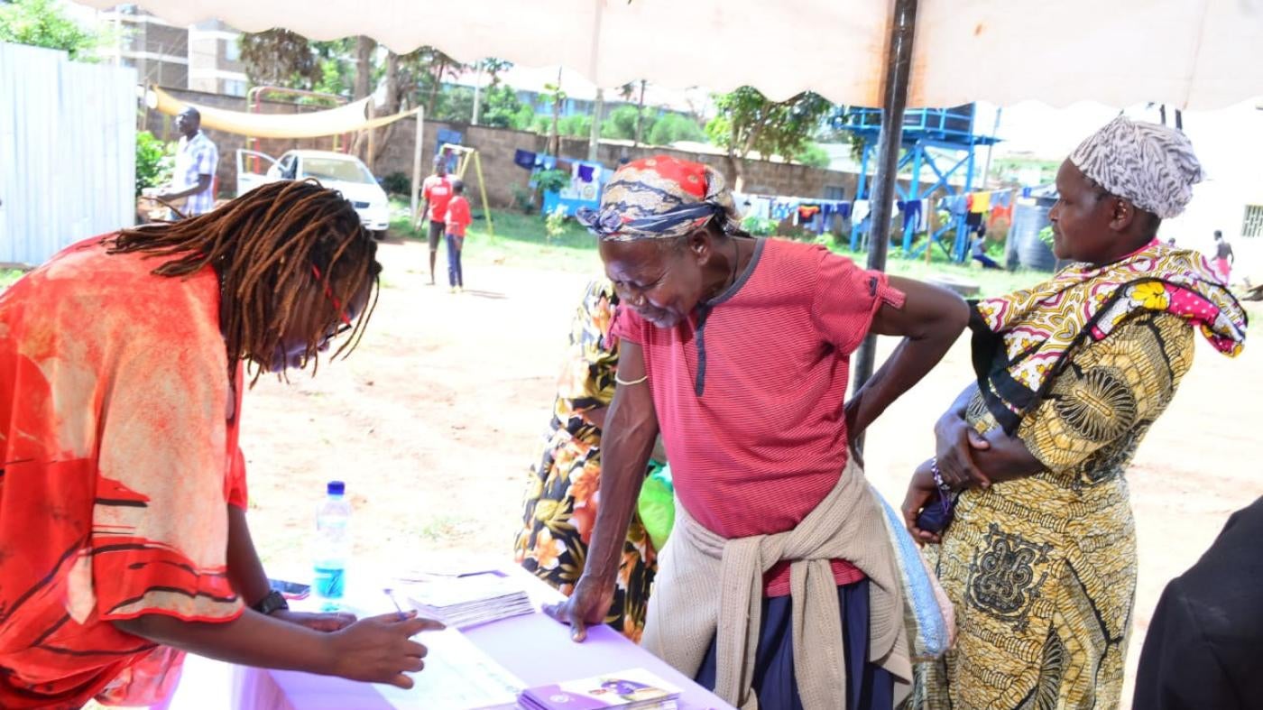 Women registering for a community dialogue meeting organized by the Federation of Women Lawyers in Kenya (FIDA-Kenya) with the Milimani Law Courts in Kibera, Nairobi.
