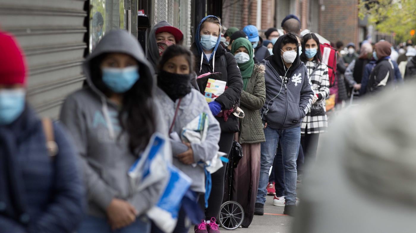 A line of people in face masks
