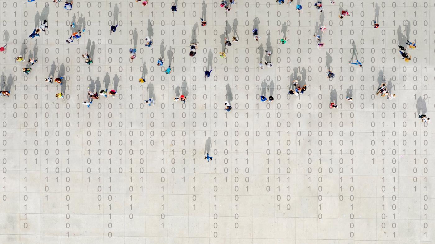 Overhead shot of people walking in lines over binary code