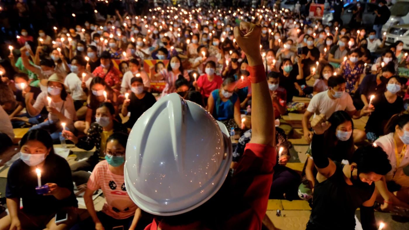 Anti-coup protesters gather during a candlelight night rally in Yangon, March 14, 2021.