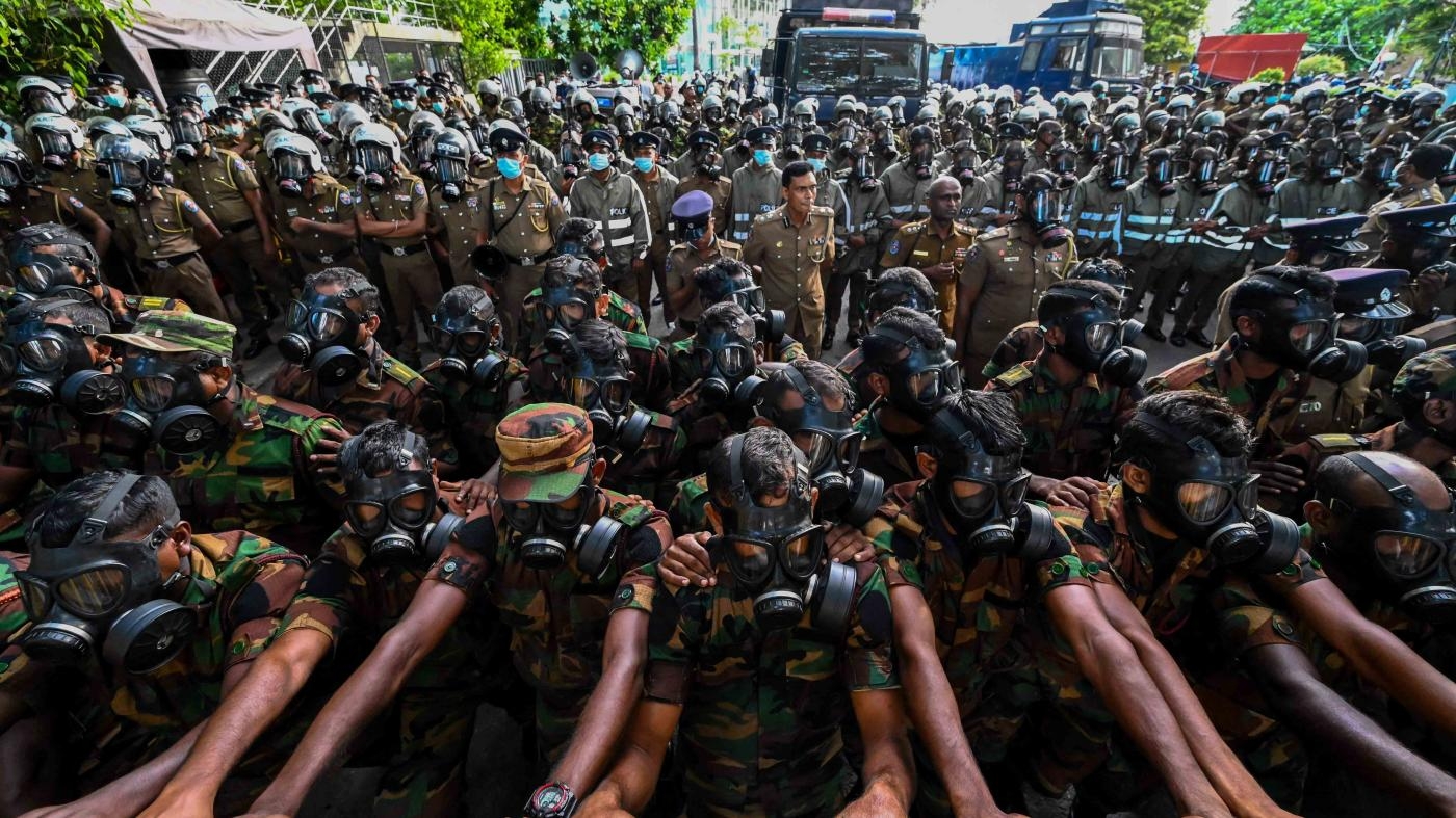  Soldiers with gas masks deployed behind barriers as protesters gather in Colombo demanding the resignation of Sri Lanka's President Gotabaya Rajapaksa over the country's crippling economic crisis, May 28, 2022.
 © 2022 Ishara S. Kodikara/AFP/Getty Images
