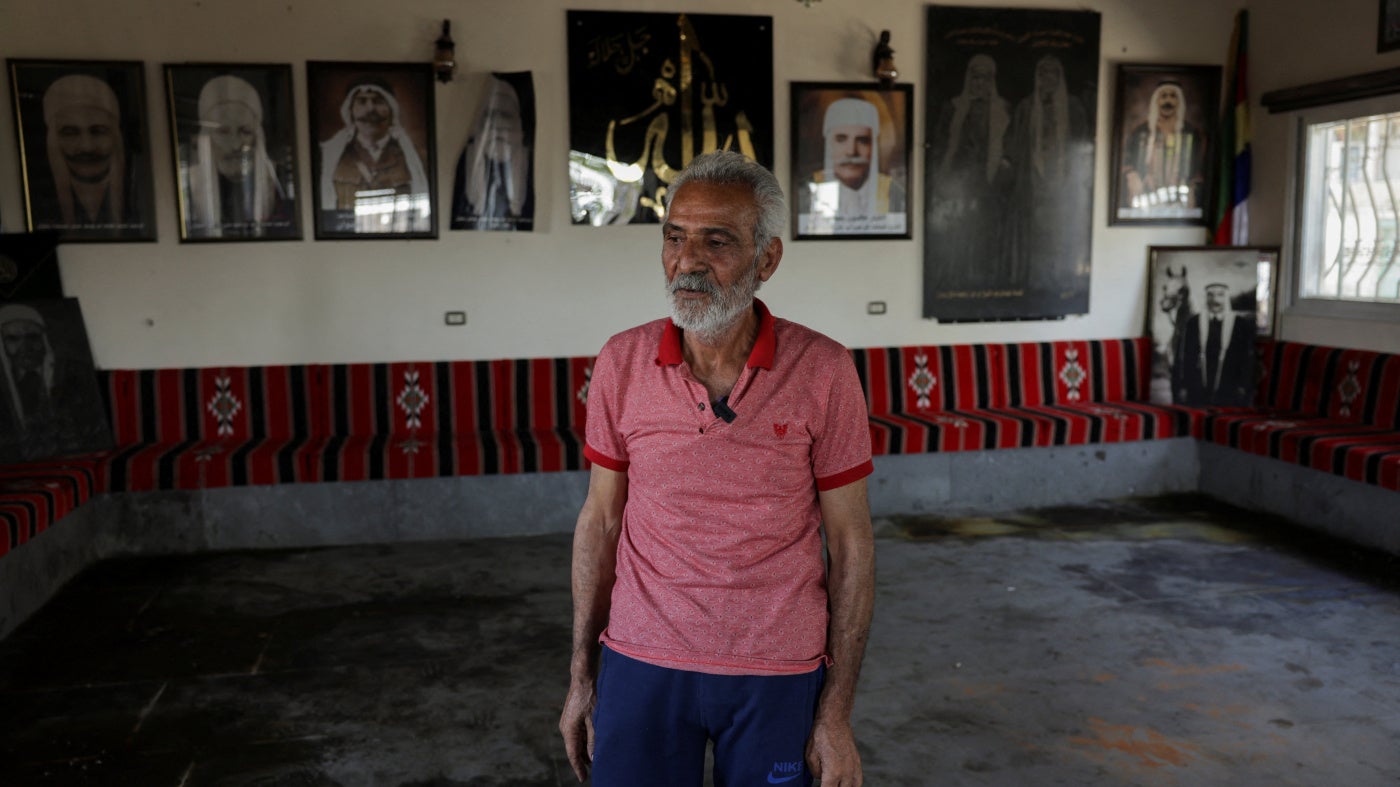 Hatem Radwan stands near bloodstains inside the Al-Radwan guest house, after a deadly shooting, in the predominantly Druze city of Sweida, Syria, July 25, 2025. 