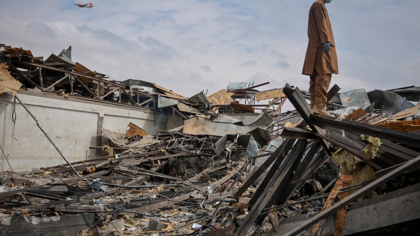 A man stands on the debris at the site of a drug rehabilitation hospital destroyed in what the Taliban said was a Pakistani airstrike on Kabul, Afghanistan, March 17, 2026.