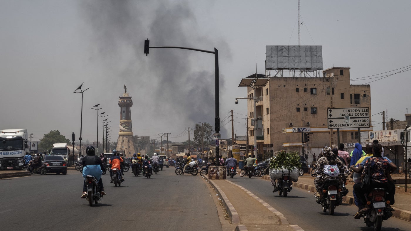 A column of black smoke rises above buildings in Bamako on April 26, 2026.