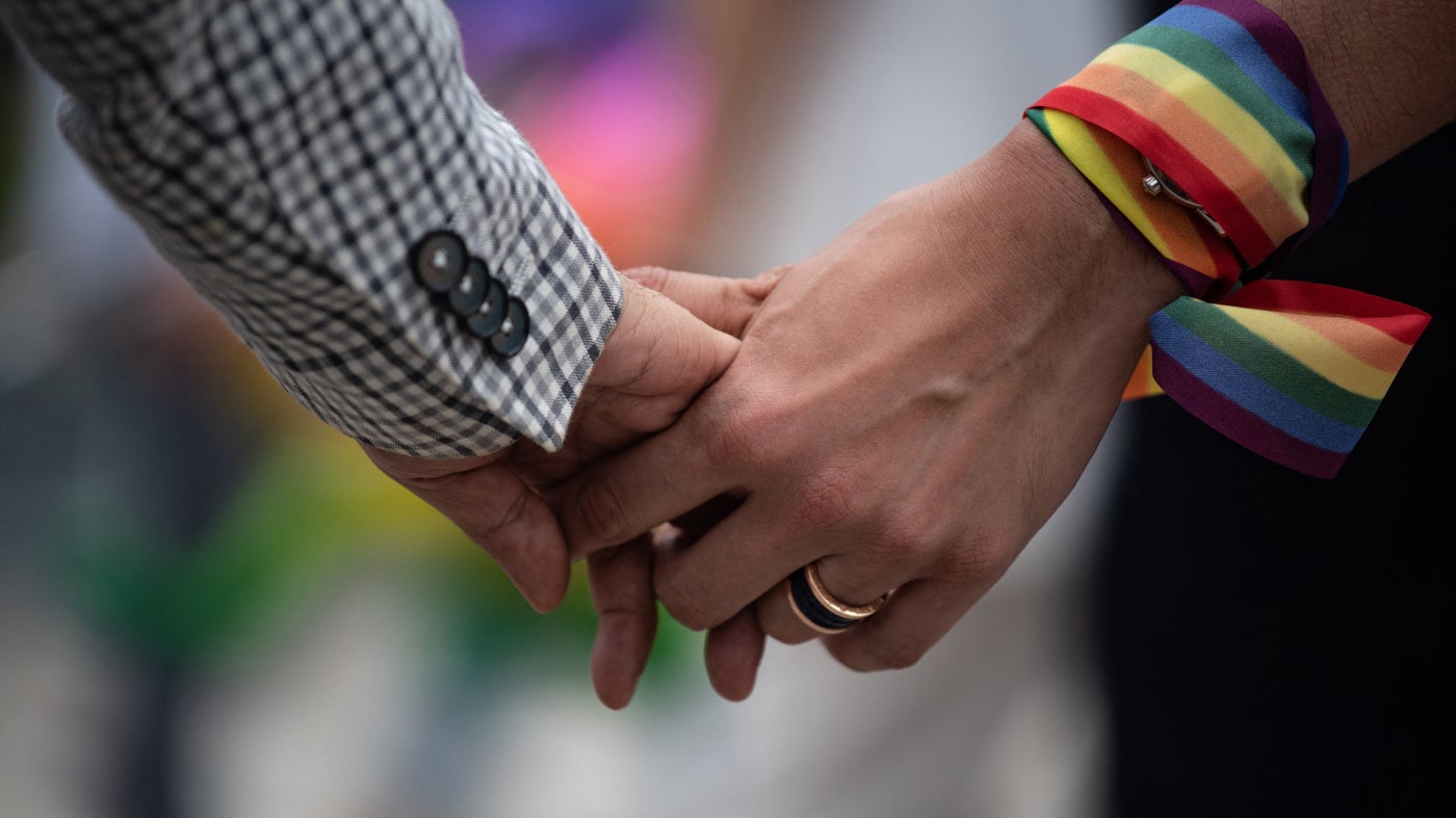 A same-sex couple hold hands during an event to raise awareness of gay rights in Hong Kong on May 25, 2019. 