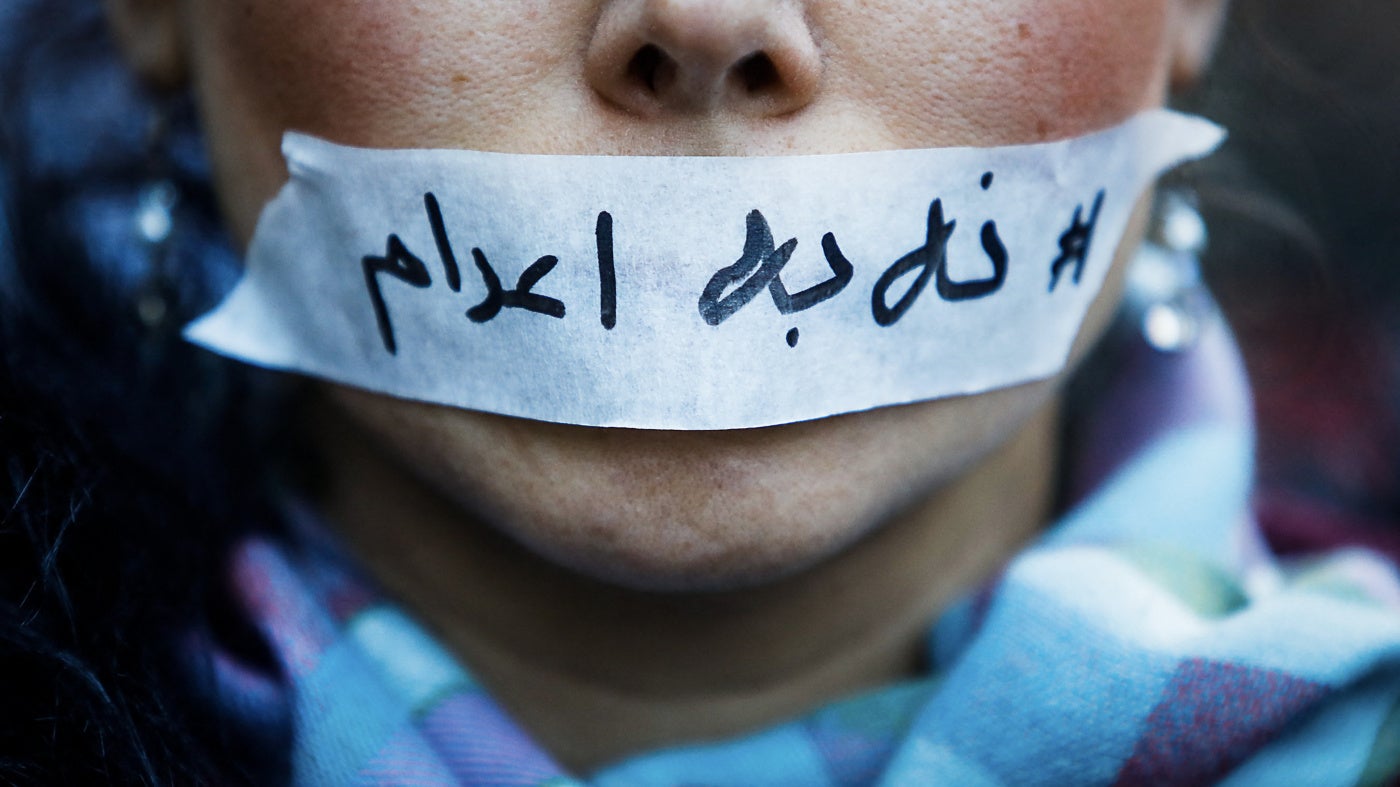 A person's mouth covered with tape bearing a message “no to executions” in Iran, in Paris in France, January 31, 2026.