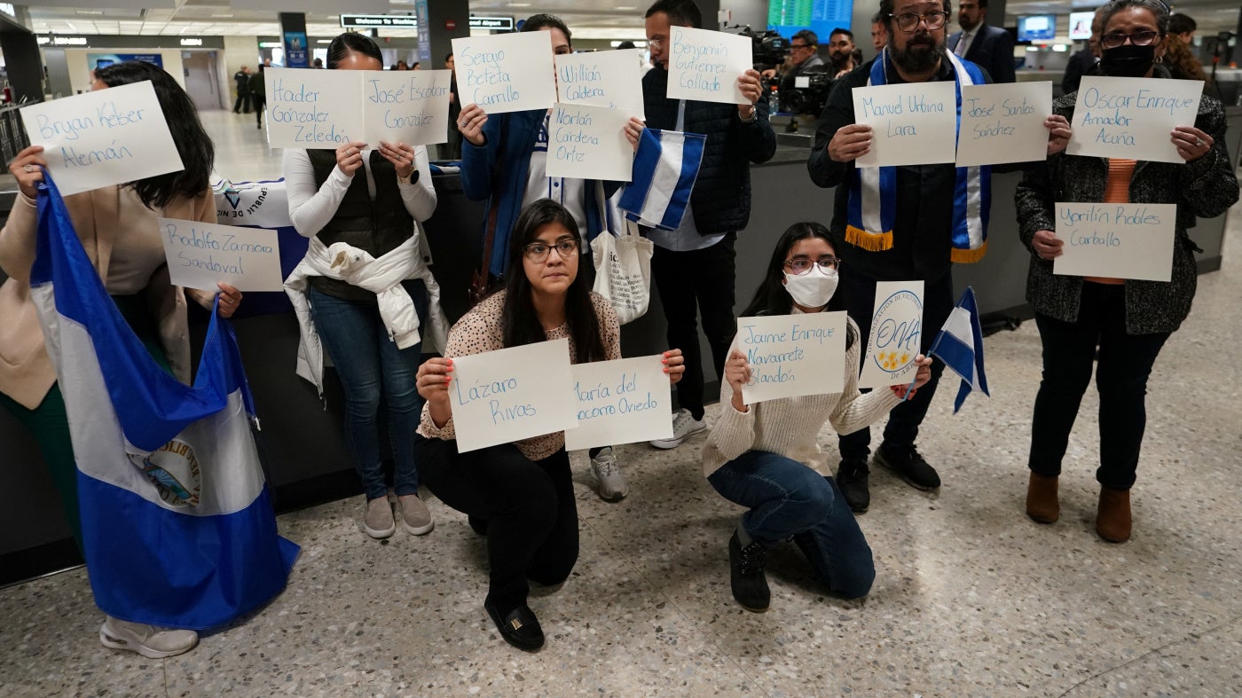 Activists hold signs with the names of some of the 222 former prisoners released and expelled by the Nicaraguan government, as they await their arrival at Dulles International Airport, Virginia, United States, February 9, 2023.