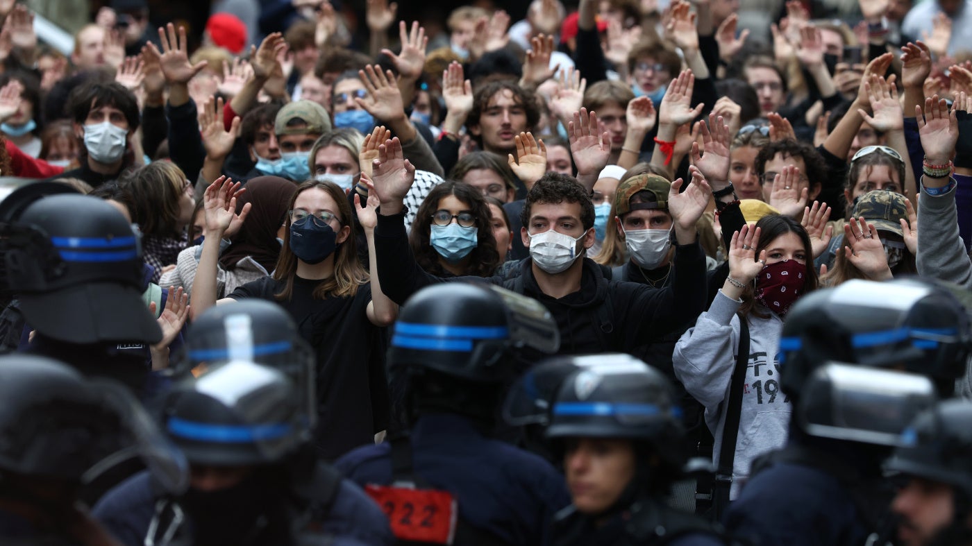 Students raise their hands in front of police officers as they demonstrate outside Sciences Po during a protest over school overcrowding and decay in Paris, France, October 7, 2026. 