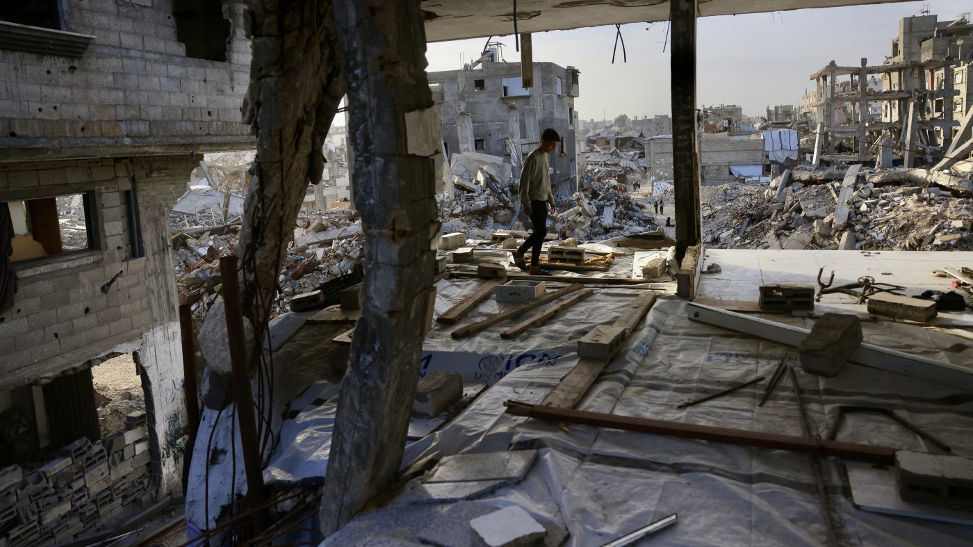 A Palestinian boy walks inside a destroyed building in Khan Yunis in the southern Gaza Strip, January 27, 2026.