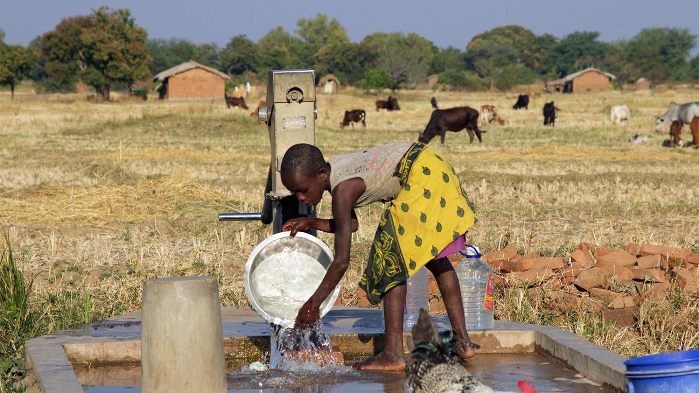Young girl washing dishes at a borehole near Eland coal mine in Mwabulambo, Karonga district. 