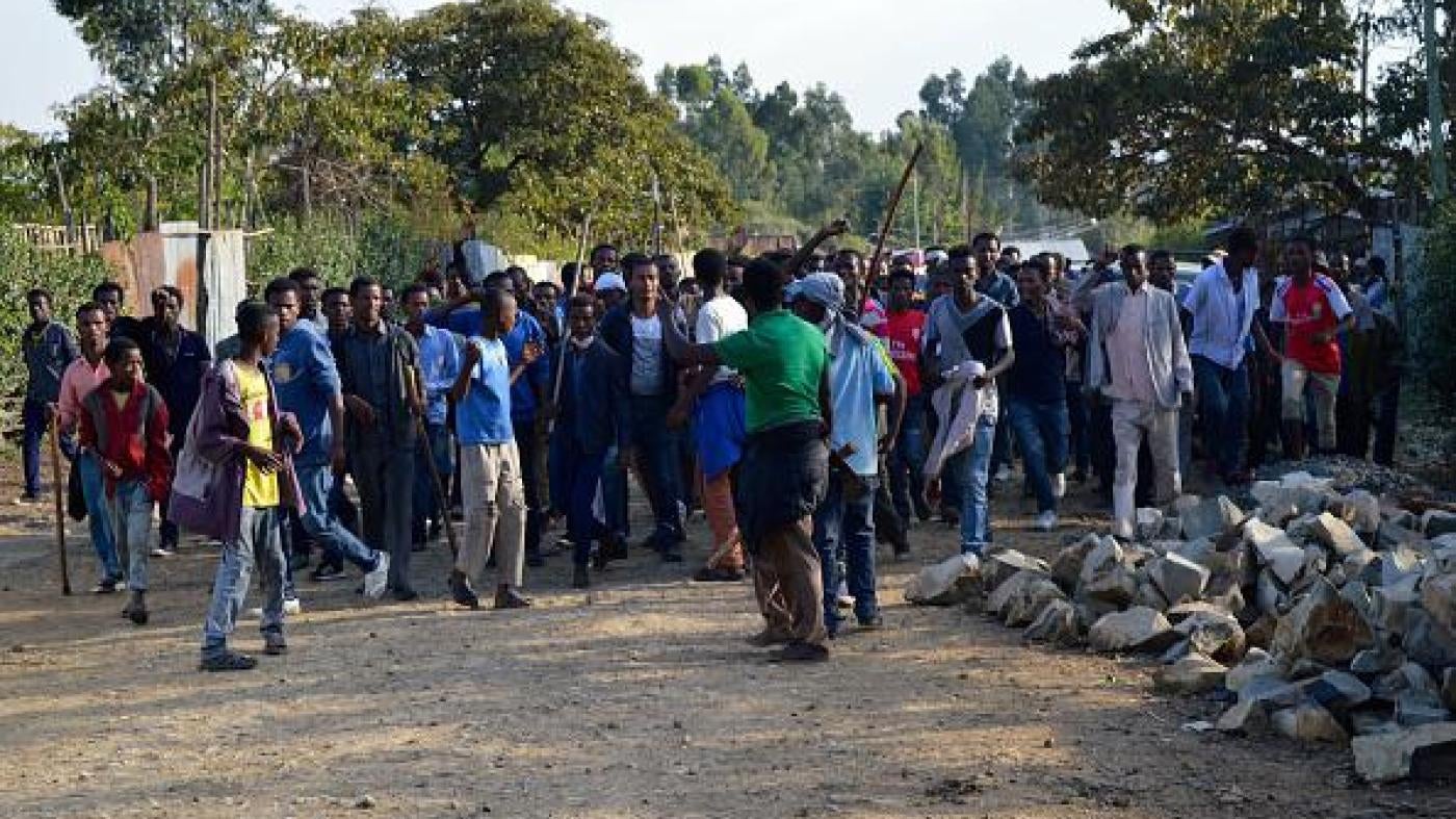 Ethnic Oromo march on a road in Ethiopia after security forces fatally shot protesters in Wolenkomi, some 60 kilometers west of Addis Ababa, December 15, 2015. 
