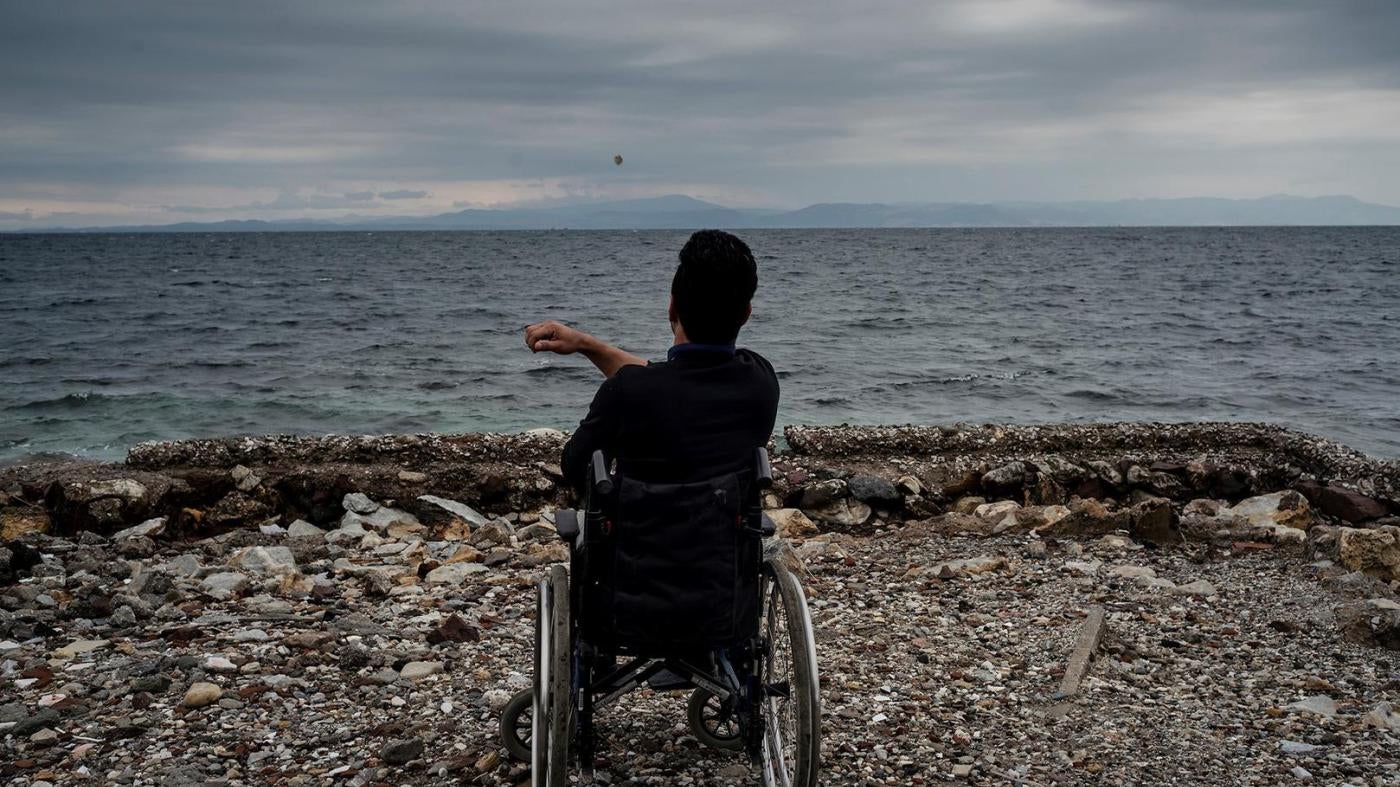 Ali, a 22-year-old Afghan asylum seeker with a disability, living in Moria camp, on the beach in Lesbos, Greece. He told Human Rights Watch he can’t access showers in the camp and sometimes tries to wash himself in the sea. 
