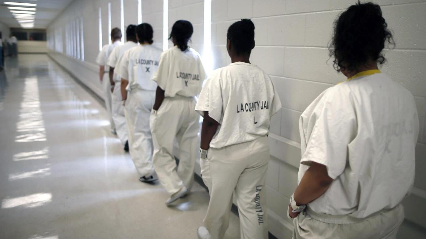 Women walk along a corridor at the Los Angeles County women's jail.