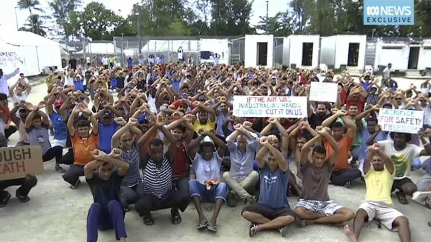 In this file photo made from Australia Broadcasting Corporation video taken on Tuesday, Oct. 31, 2017, shows asylum seekers protesting the possible closure of their detention center on Manus Island, Papua New Guinea.