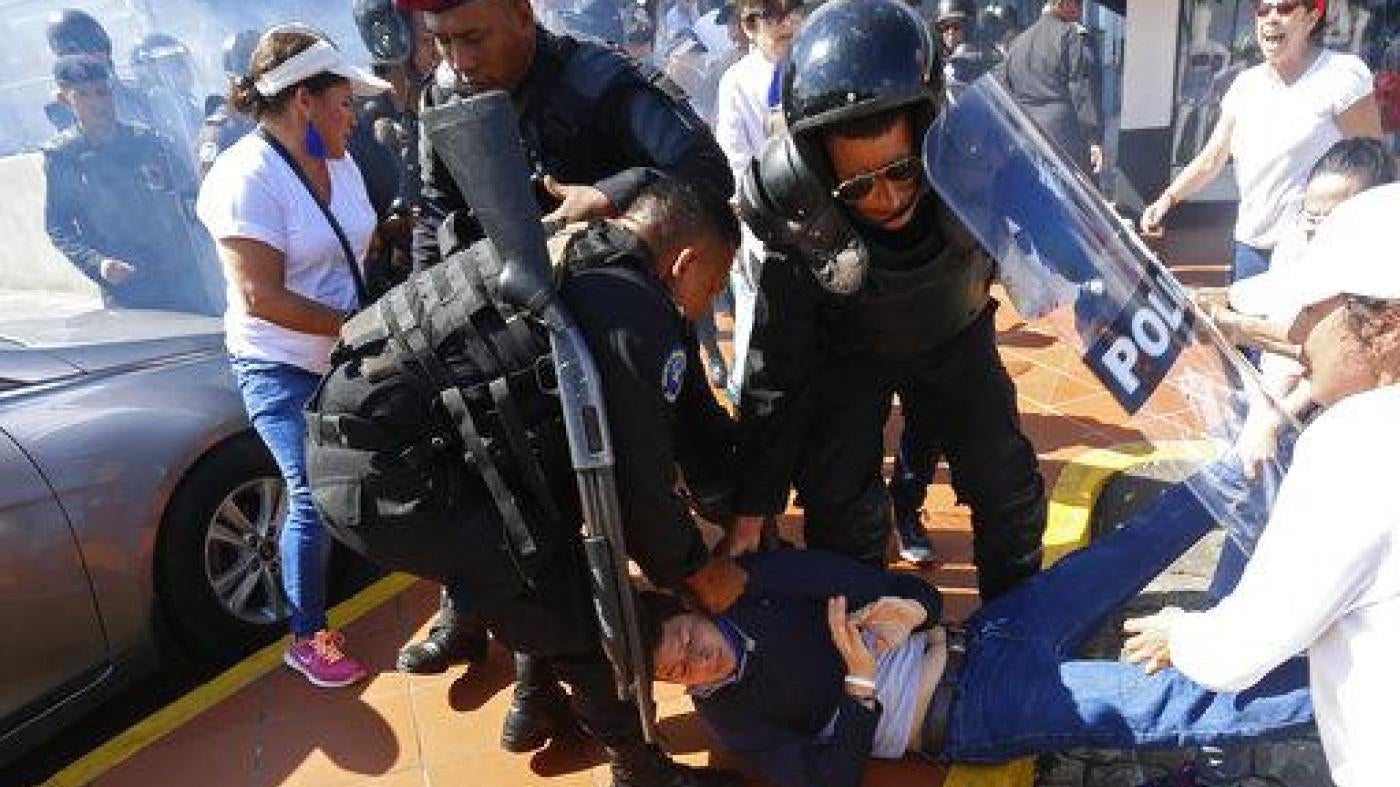 An anti-government protester is dragged away and arrested by police as security forces disrupt an opposition march coined "United for Freedom" in Managua, Nicaragua, Sunday, Oct. 14, 2018.