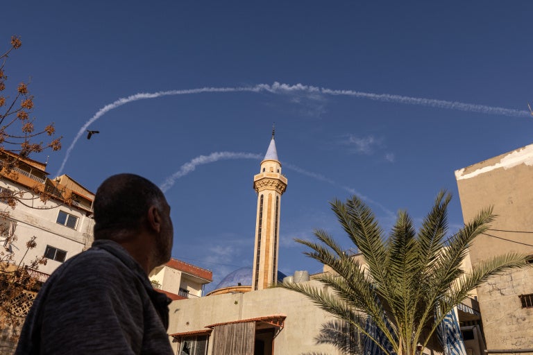 Contrails from Israeli fighter jets in the sky over Tyre, Lebanon, March 24, 2026.