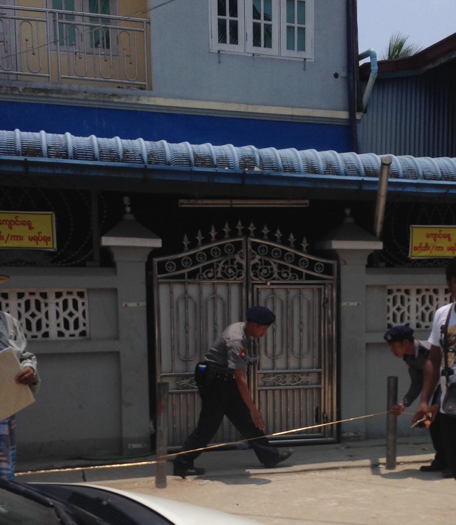 Police officers place yellow tape across the entrance to one of the madrasas in Thaketa Township, Rangoon, April 29, 2017.
