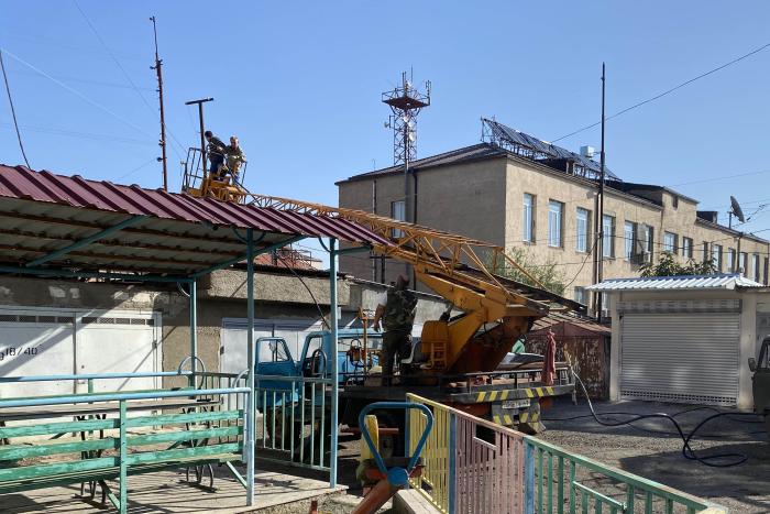 Workers attempt to repair damaged electrical lines