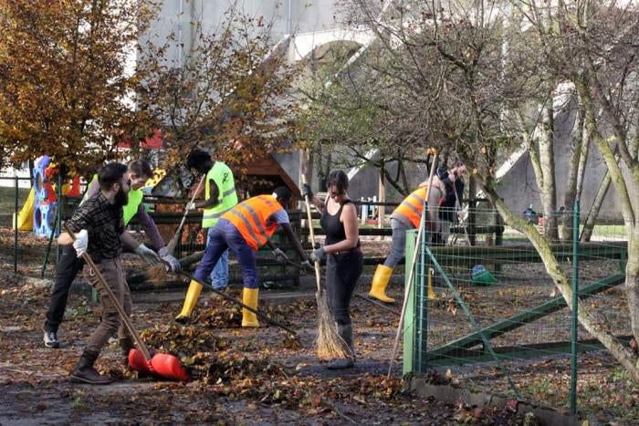 Italians and asylum seekers from the local specialized reception center work together to clear debris after floods in Belluno, Italy,&nbsp;November 2018. 