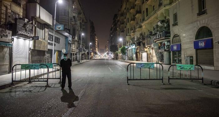 Egyptian security forces cordon off roads during curfew hours in Cairo, Egypt, Sunday, March 29, 2020