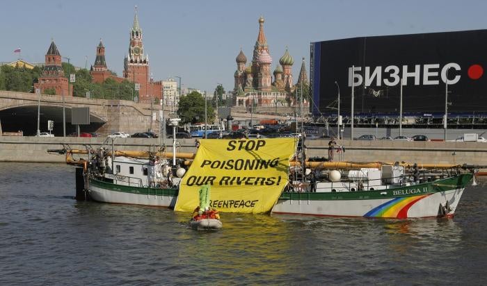 Members of the Russian branch of the environmental group Greenpeace display a protest banner in downtown Moscow on Thursday, May 20, 2010. 