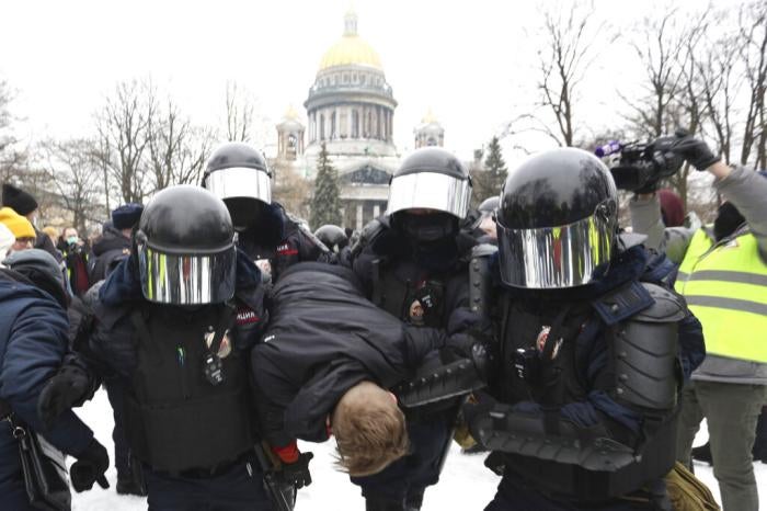 Police officers detain a protester during a rally in support of Alexei Navalny in St. Petersburg, Russia, on January 23, 2021.&nbsp;