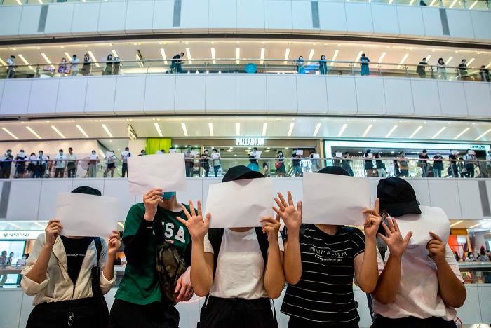 Protesters hold up blank papers during a demonstration in a mall in Hong Kong on July 6, 2020, in response to the Hong Kong government’s ban of the 2019 protest slogan, “Liberate Hong Kong, the Revolution of Our Times.