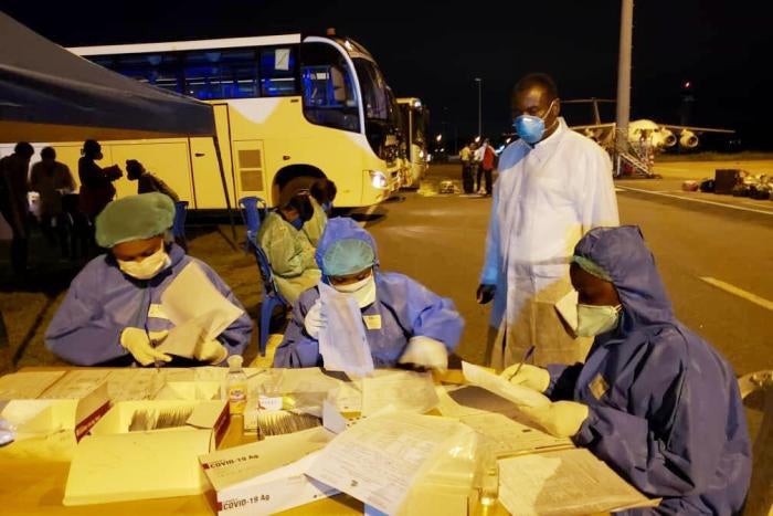 CDC Cameroon Associate Director for Program and Science, Dr. Clement Ndongmo, observes Covid-19 testing procedures for passengers arriving at Nsimalen International Airport in Yaound&eacute;.&nbsp;