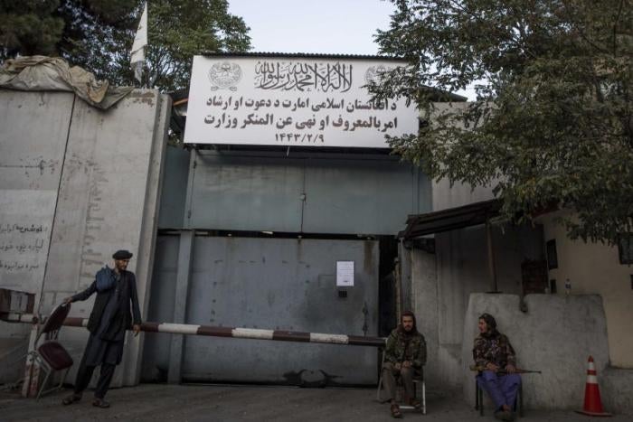 Taliban fighters stand guard at the entrance to the former Ministry of Women Affairs, which the Taliban has replaced with the Ministry of Vice and Virtue, which oversees the implementation of hardline Islamic rules in Afghanistan.&nbsp;
