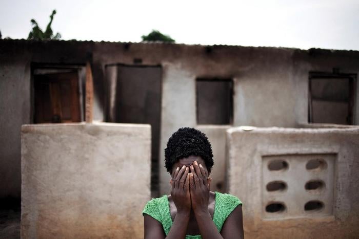 A woman hides her face after recounting how pro-Ouattara forces killed two of her children and her brother during the post-election violence in Du&eacute;kou&eacute;, western C&ocirc;te d&rsquo;Ivoire.