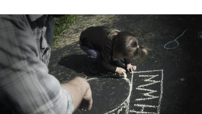 A father plays with his daughter, who was born with atypical sex characteristics. Despite pressure from doctors, the parents chose not to elect medically unnecessary surgeries on their child. 