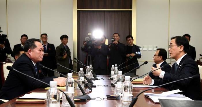 Head of the North Korean delegation, Ri Son Gwon talks with South Korean counterpart Cho Myoung-gyon during their meeting at the truce village of Panmunjom in the demilitarised zone separating the two Koreas, South Korea, January 9, 2018. 