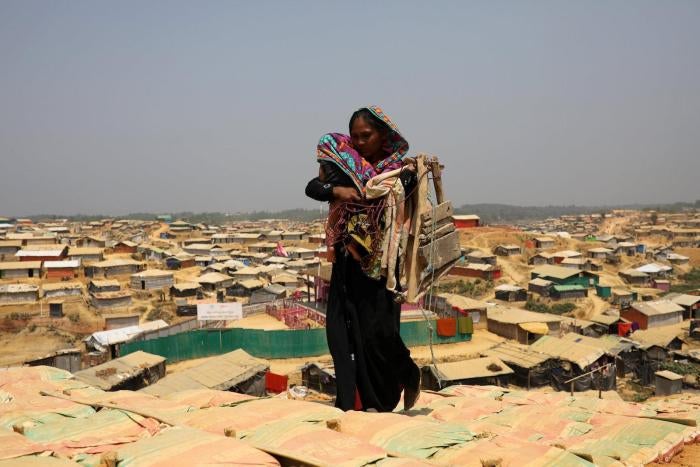 A Rohingya woman walks through Kutupalong refugee camp in Cox&rsquo;s Bazar, Bangladesh, March 22, 2018.