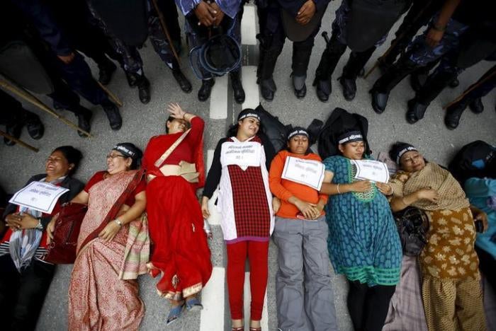 Women activists lie down on the road during a protest demanding women&rsquo;s rights in the constitution in Kathmandu, Nepal, August 7, 2015.