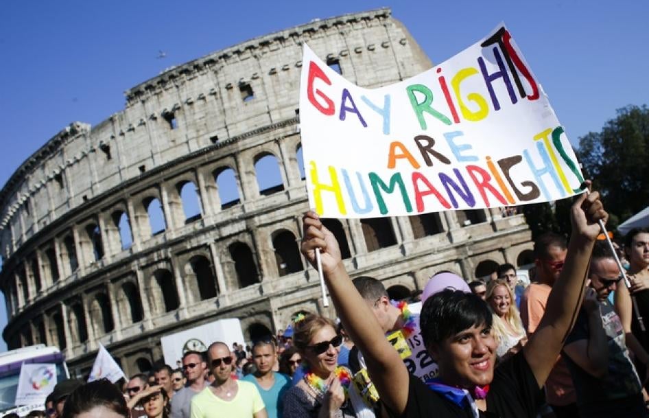 Una donna con un cartello davanti al Colosseo durante il gay pride del 15 giugno 2013 a Roma.  © 2013 Reuters
