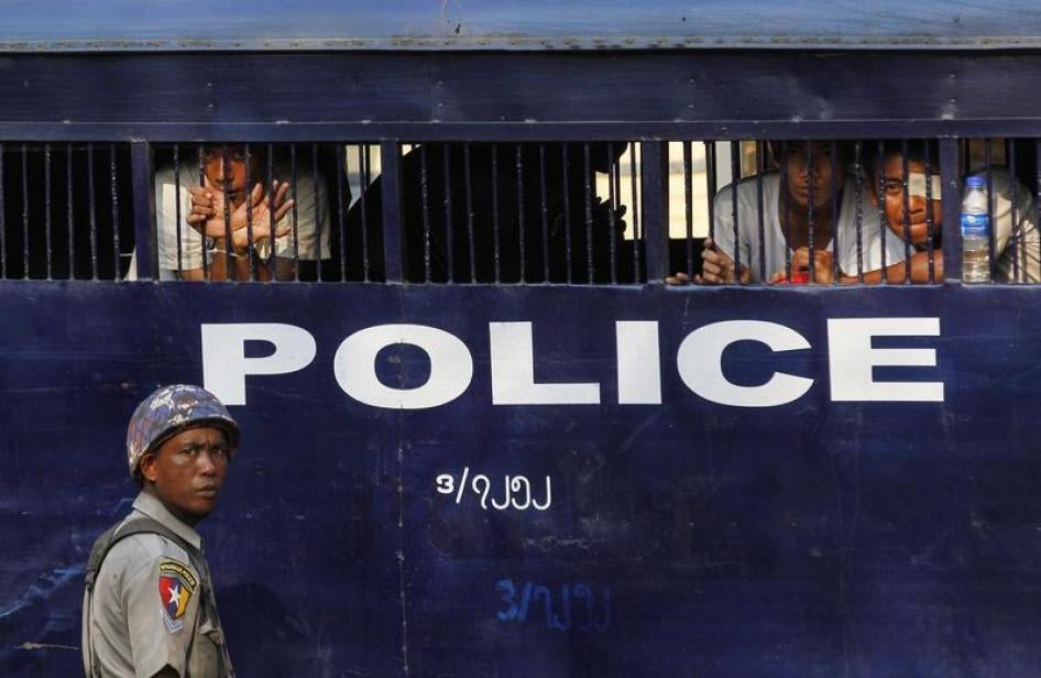 Student protesters look out from a prison vehicle as they are transported to a court in Letpadan on March 11, 2015.