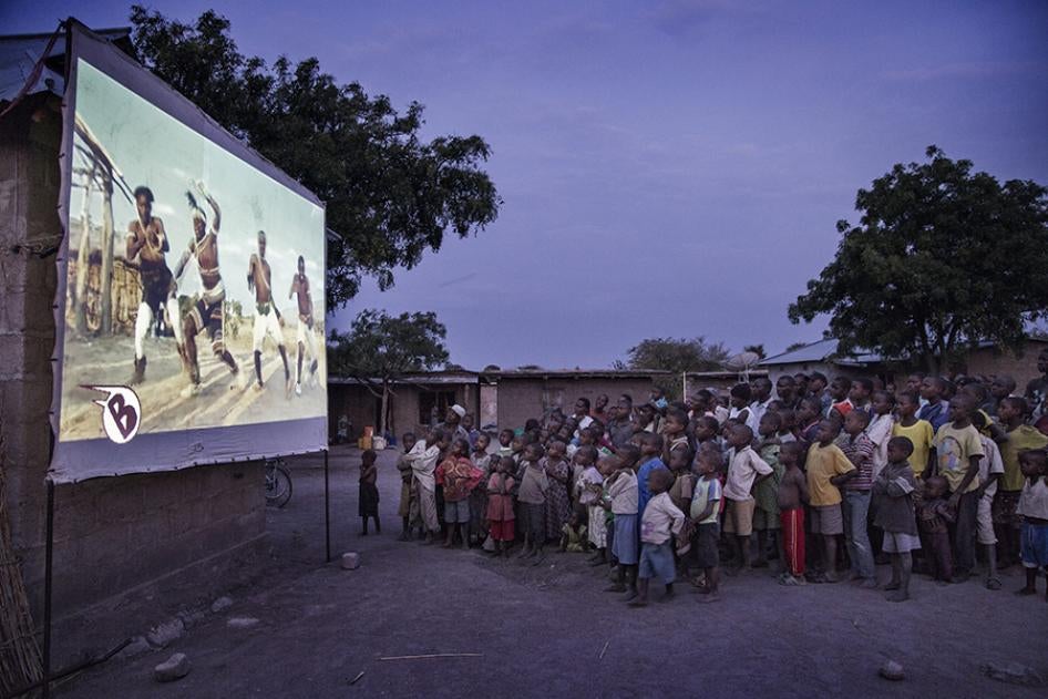 Children watch a video at an outreach event held by Agape AIDS Control Program, a nongovernmental organization working to end child marriage. 