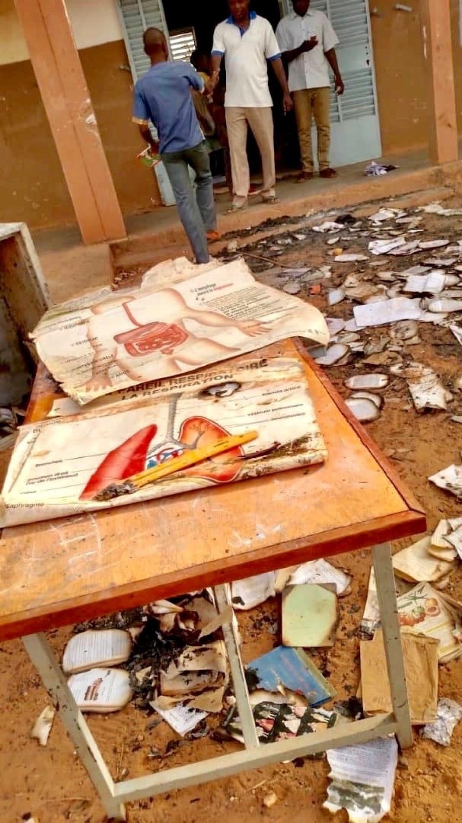 School desk with burned books