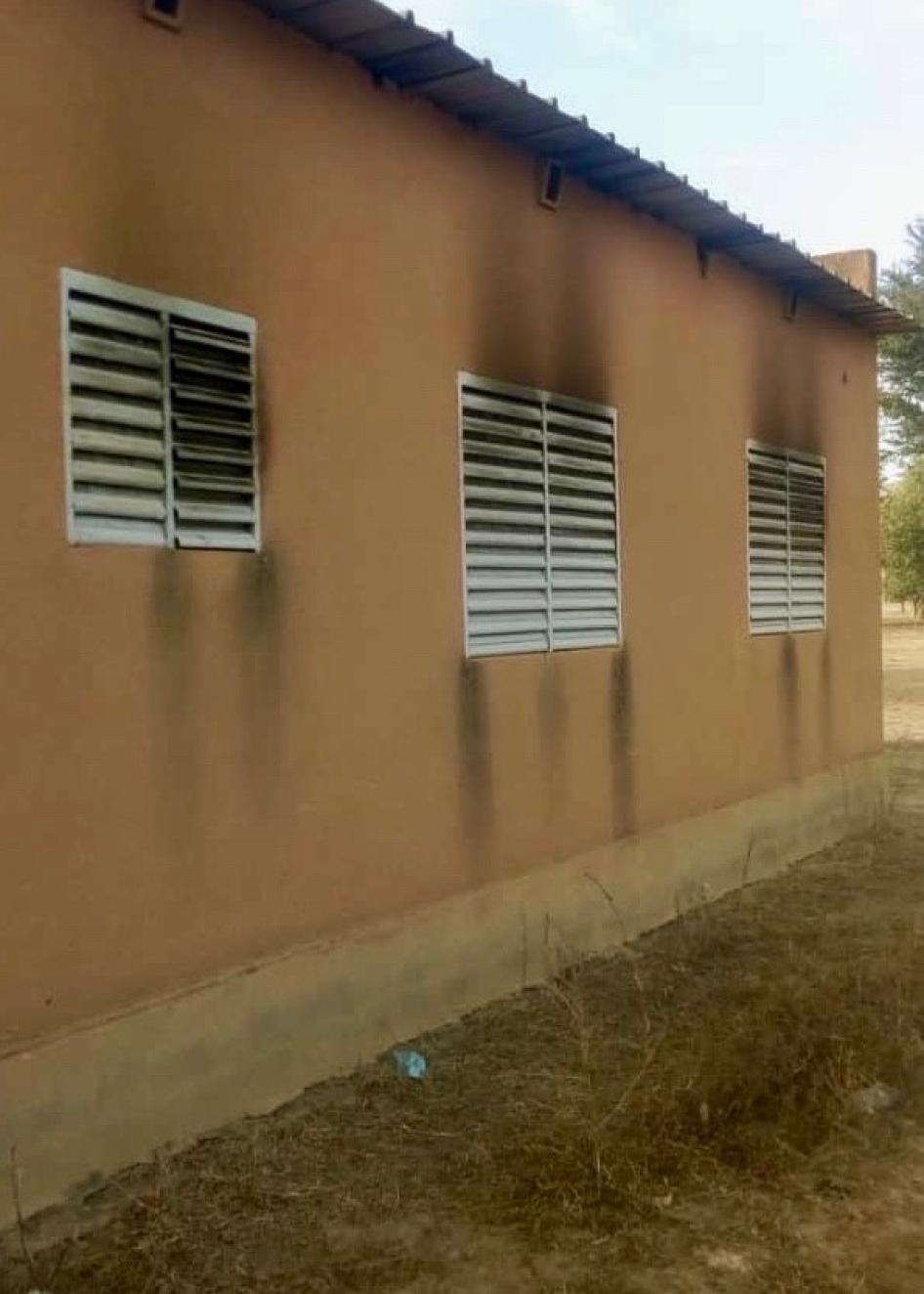 Burn marks on the side of a yellow building