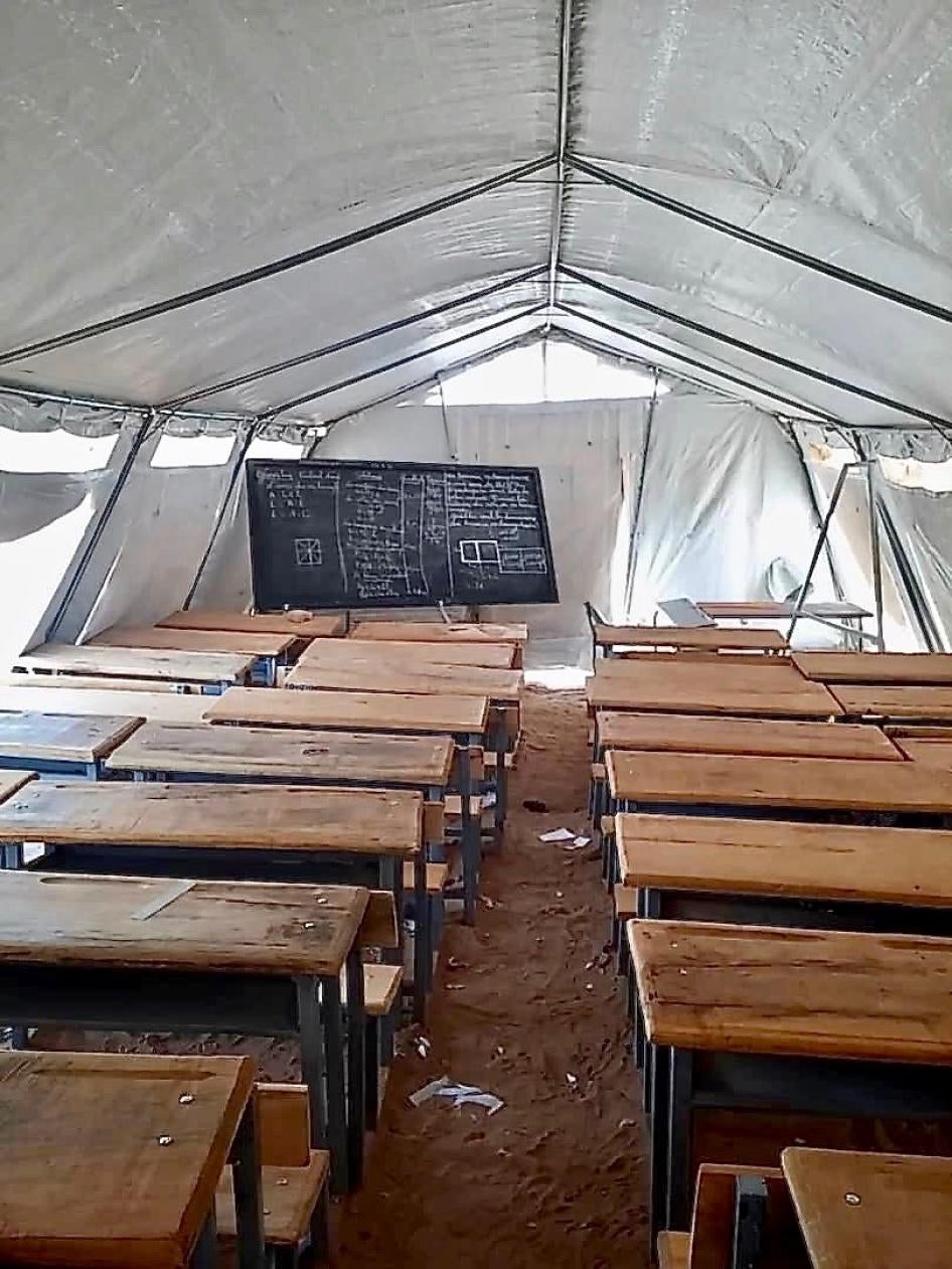 Rows of desks in a tent
