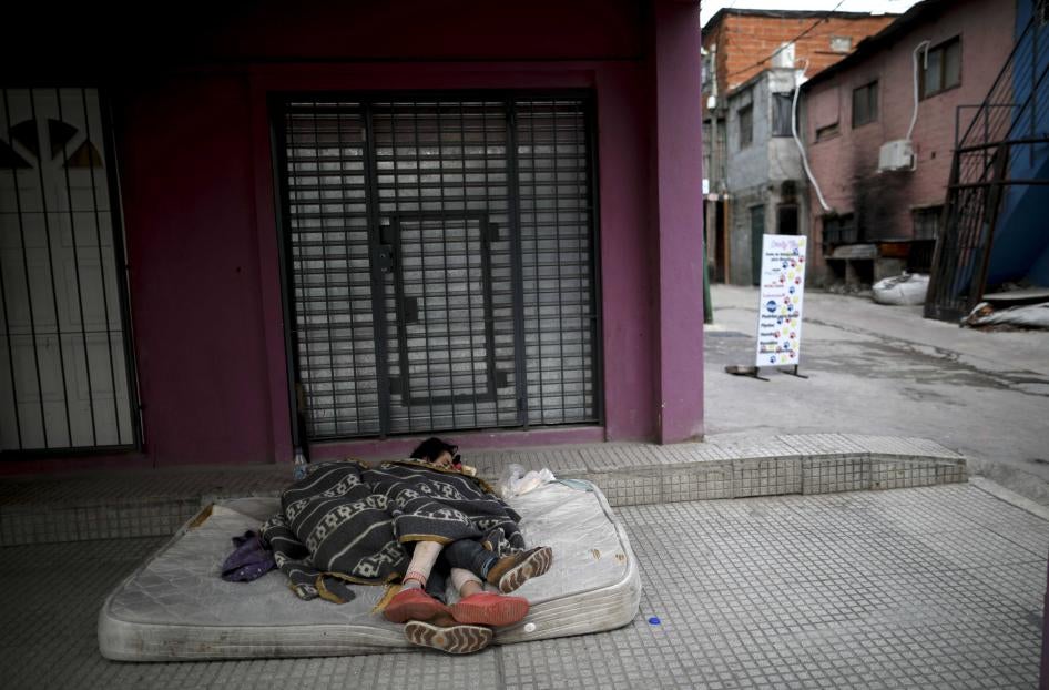 Homeless women sleep outside on a mattress in the "Villa 31" neighborhood during a government-ordered lockdown to curb the spread of the new coronavirus in Buenos Aires, Argentina, Wednesday, May 6, 2020. 