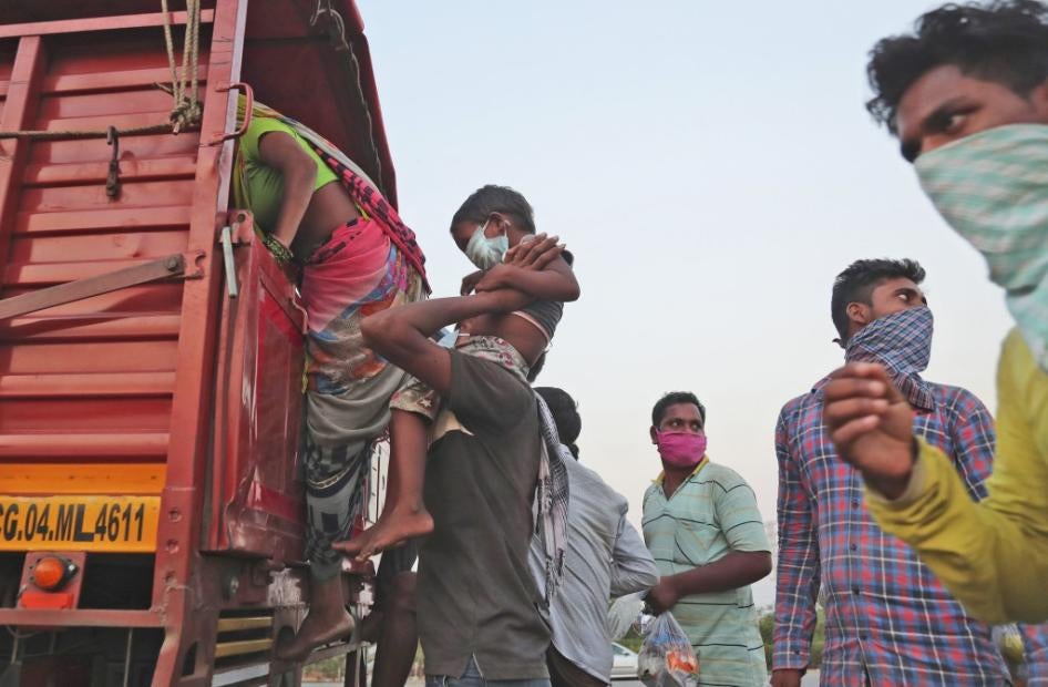 Migrant workers board a truck to return to their villages during a nationwide lockdown, Hyderabad, India, May 12, 2020.