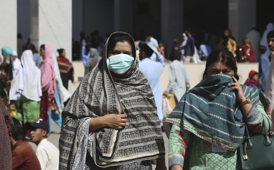 Pakistani women wearing face masks leave the Aga Khan hospital where a patient suspected of having contracted coronavirus was admitted, in Karachi, Pakistan, Thursday, Feb. 27, 2020. 