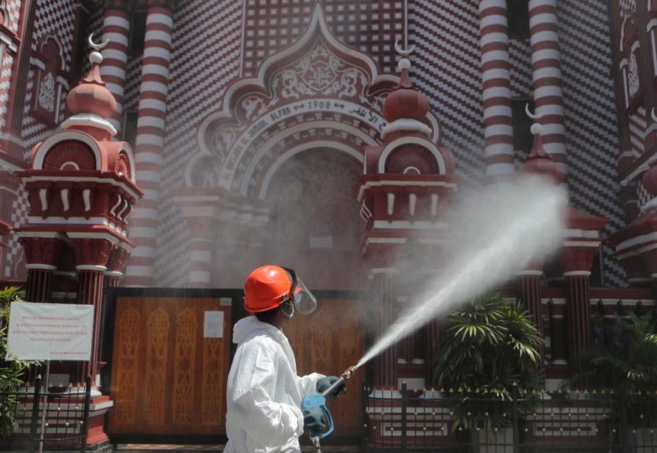 A Sri Lankan firefighter sprays disinfectants near a mosque in Colombo, Sri Lanka