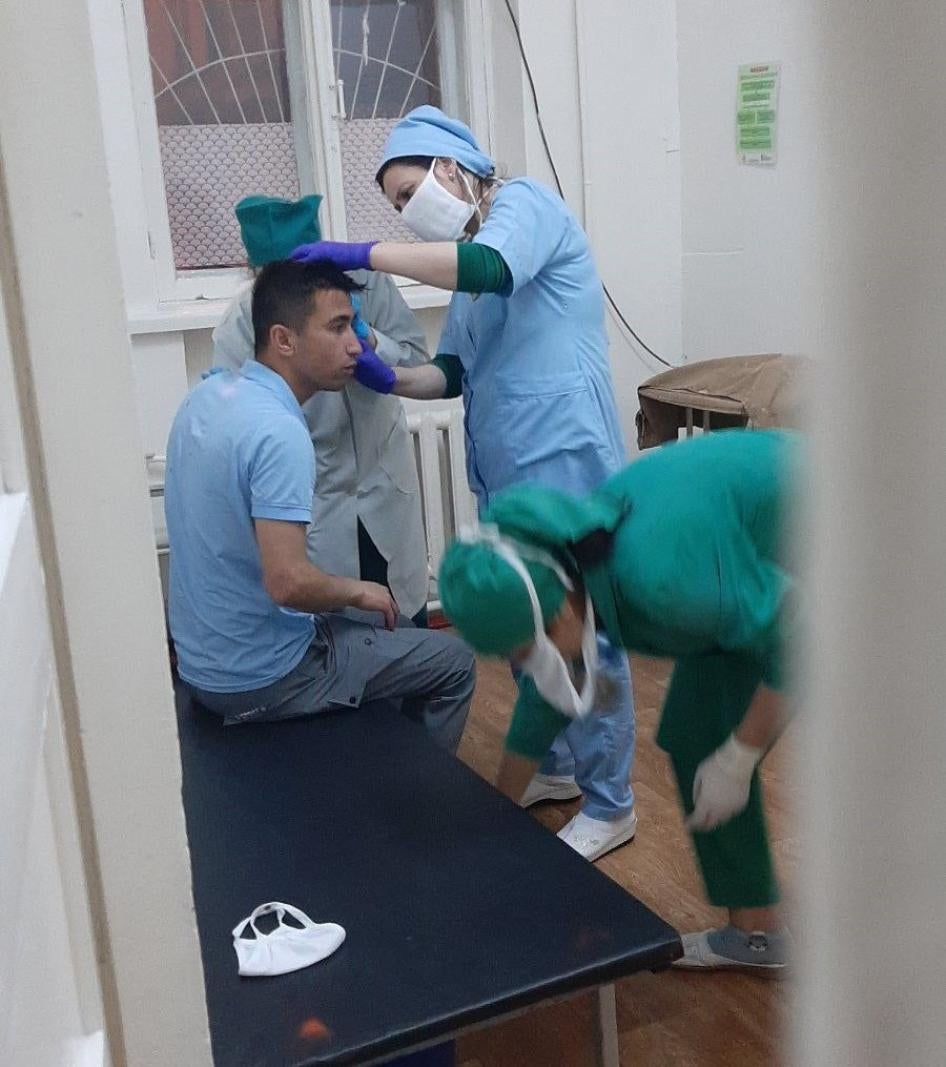 Abdulloh Ghurbati receives medical help after an attack on May 11, 2020, Dushanbe, Tajikistan.