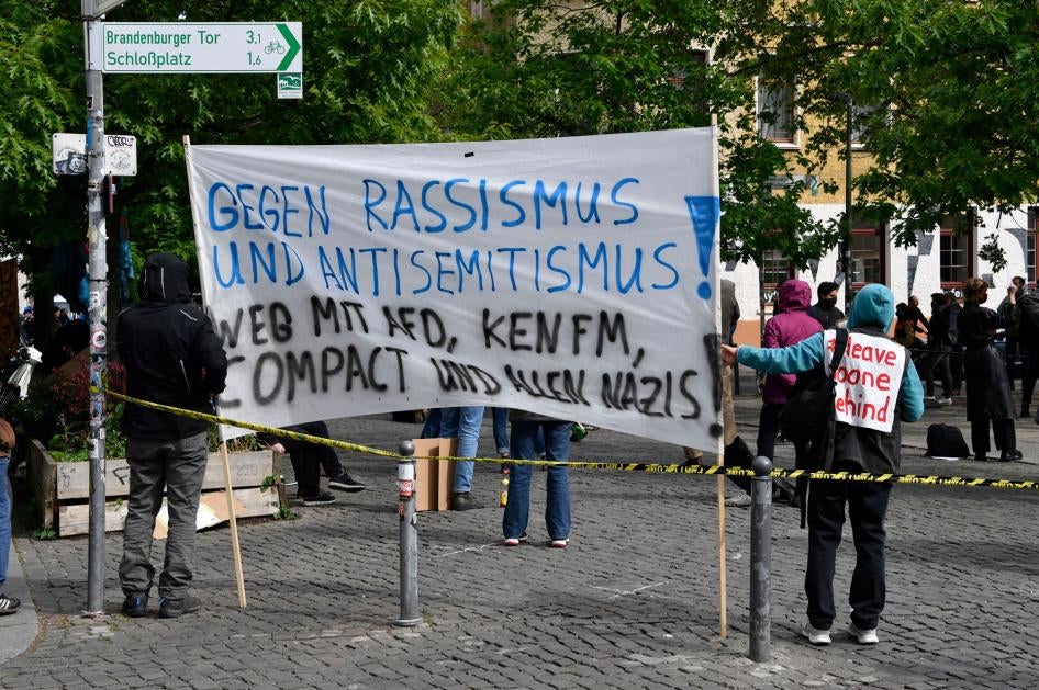 Calling our racism: Demonstrators gather to oppose messages of discrimination at protests over Covid -19 containment measures. The sign reads “Against racism and anti-Semitism”. Rosa-Luxemburg Platz, Berlin, 16 May 2020.