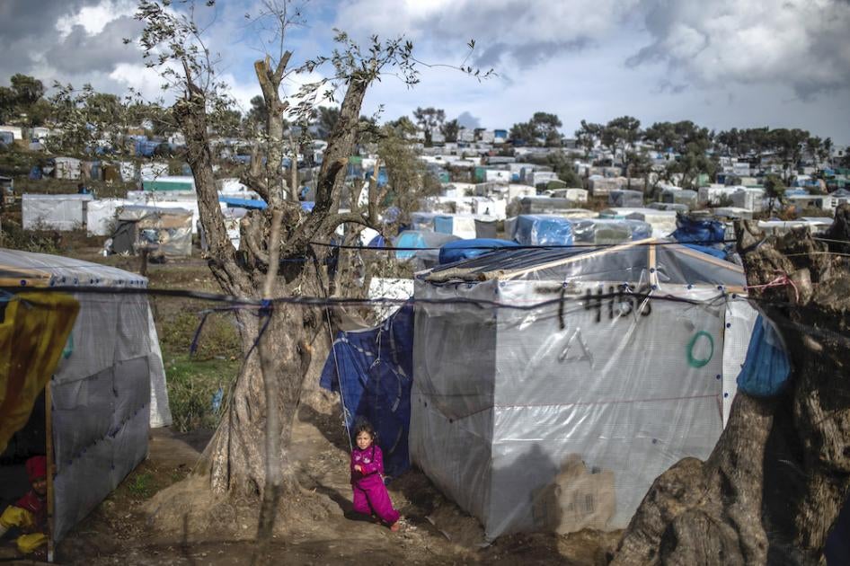 A child plays in a temporary tent camp near the camp for migrants in Moria, Lesbos which is overcrowded and lacks adequate hygiene facilities and sanitation, putting migrants, including pregnant people, at particular risk amid Covid-19